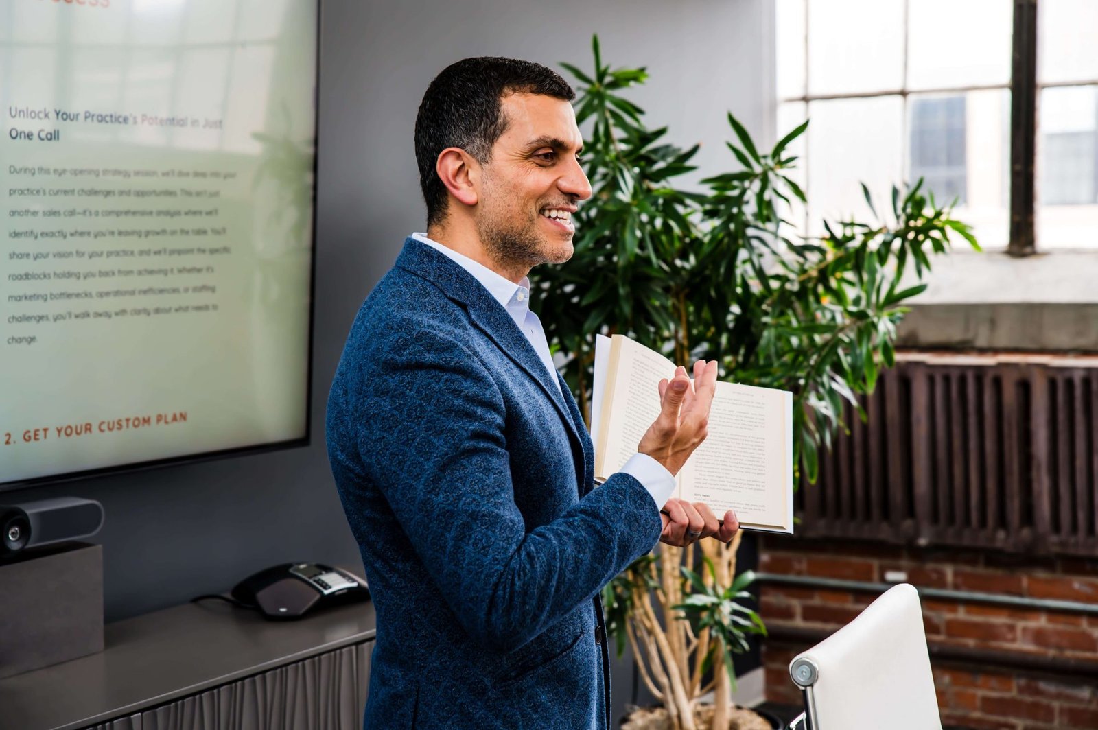 A cohesive chiropractic team communicating effectively at the front desk and adjustment area