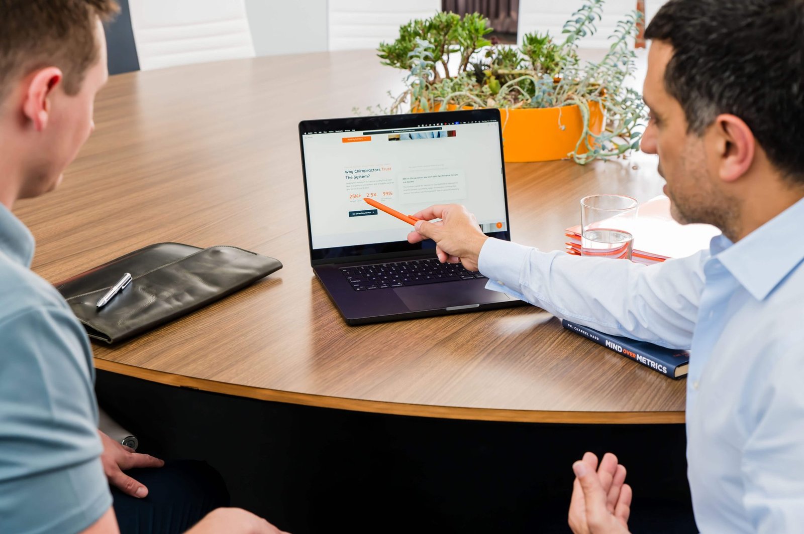 chiropractor discussing care plan with patient in clinic office