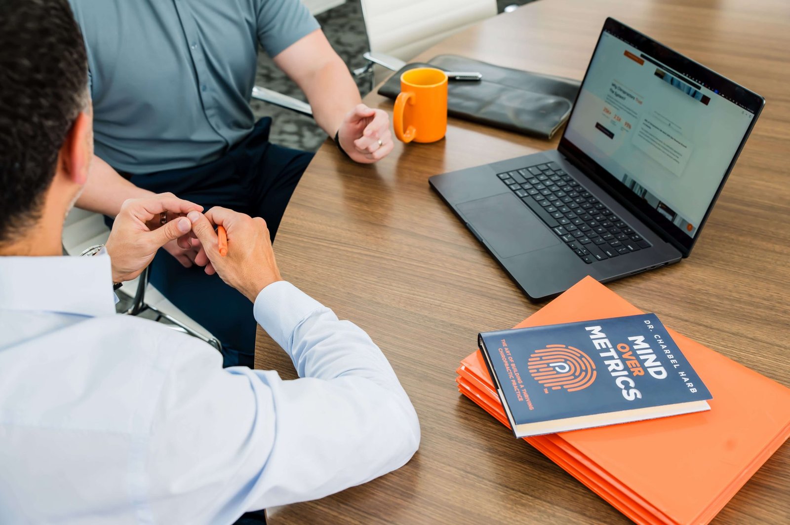 Chiropractor managing personal injury case paperwork and attorney communication at desk