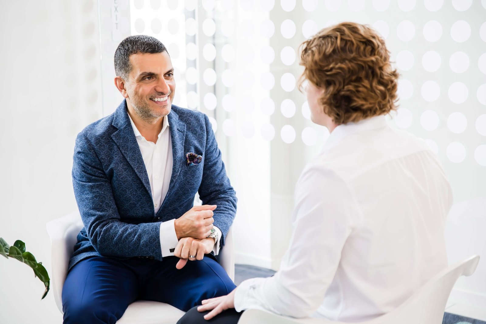 Chiropractor consulting with patient while reviewing notes and legal documentation