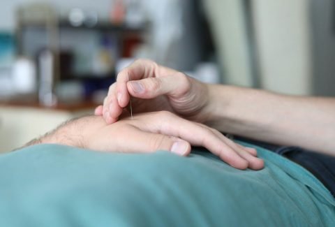 A person is holding the hand of another person