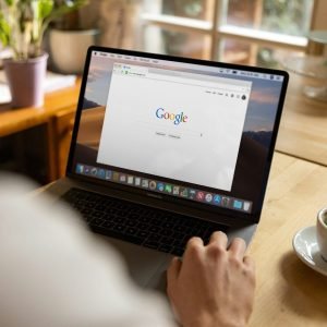 person using macbook pro on table